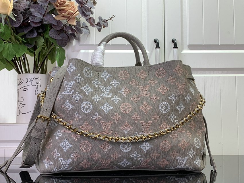 Louis Vuitton M23395 Bella Tote handbag combines a bucket bag  travel bag with perforated cow leather