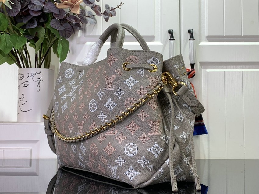 Louis Vuitton M23395 Bella Tote handbag combines a bucket bag  travel bag with perforated cow leather