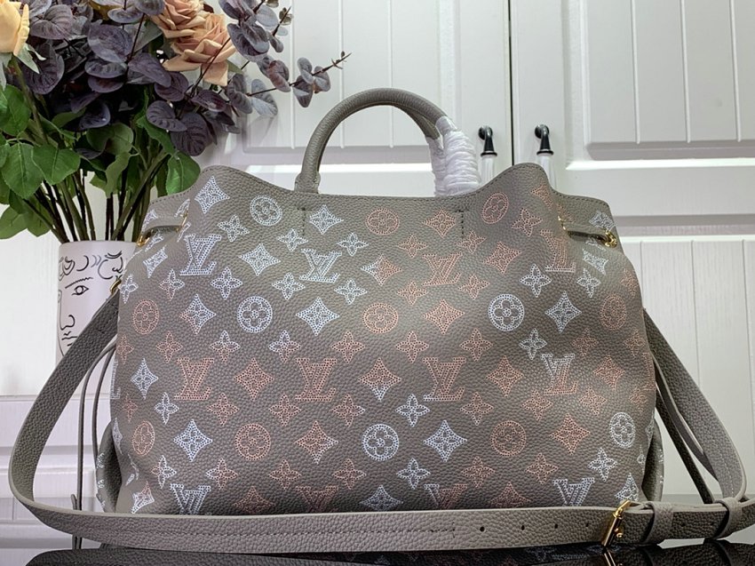 Louis Vuitton M23395 Bella Tote handbag combines a bucket bag  travel bag with perforated cow leather